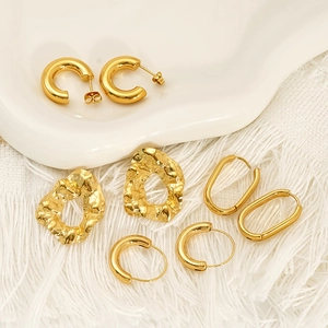 Set of four gold chunky irregular and oval hoop earrings in polished titanium steel