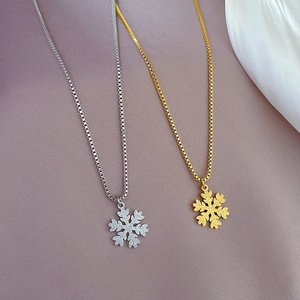 Minimalist snowflake pendants in gold and silver steel on elegant box chains