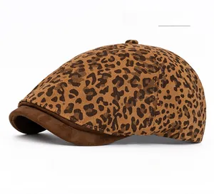 Detailed close-up of dark khaki leopard print fabric and suede brim on retro ivy cap