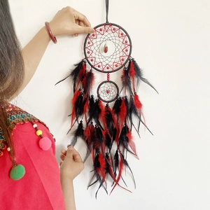 Handmade dreamcatcher with black and red feathers and gemstone detail wall hanging decoration