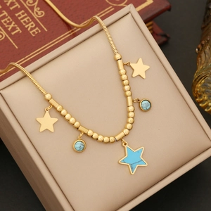 Golden necklace with turquoise stars and beads displayed in a premium jewelry box