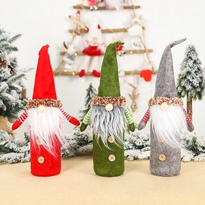 Three Christmas gnome wine bottle covers in red green and grey for festive home decor