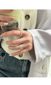 Detailed view of layered S925 sterling silver bead rings on finger with elegant styling