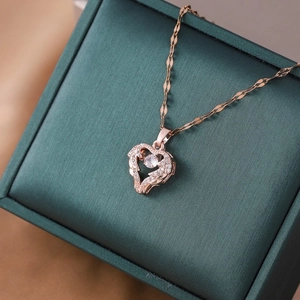 Elegant rose gold heart pendant necklace with clear zircon on green jewelry box