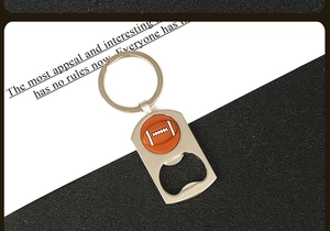 Detail showing a silver metal bottle opener keychain with an orange rugby ball ornament