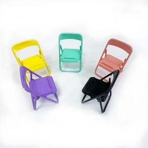 Colorful foldable chair phone stands in macaron colors on a white background