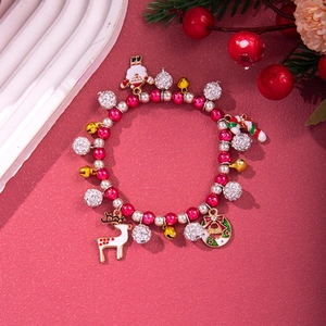 Detailed view of Christmas themed charm bracelet with reindeer and santa claus pendants