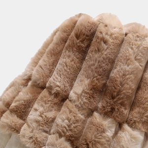 Macro view of plush vertical striped faux fur texture in brown on bucket hat