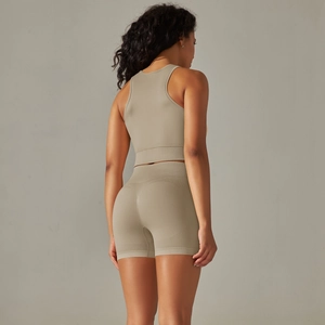 Back view of beige seamless knitted yoga crop top and high-waisted fitness shorts