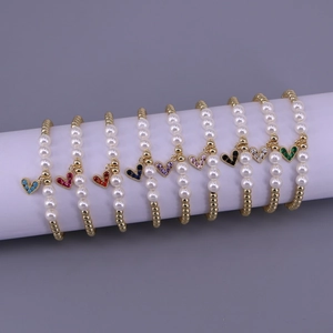 Set of nine pearl and gold bead bracelets with colorful zircon heart charms