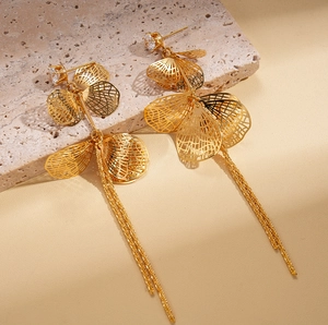 Détail de boucles d'oreilles à pampilles plaquées or 18k avec motif de feuille évidée