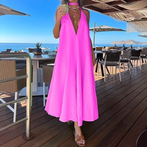 Detail view of hot pink V-neck halter maxi dress featuring backless cut for beach vacation