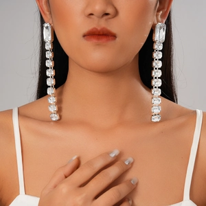 Elegant long rectangular acrylic rhinestone fringe earrings worn by a model in close-up shot