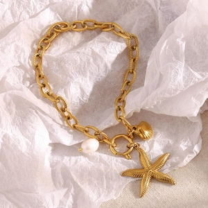 Detail of 18K gold-plated anklet featuring pearls, starfish, and shell charms