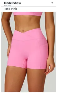 Close-up of rose pink high-waisted yoga shorts featuring cross-waist design and side pockets