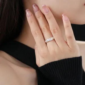 Minimalist silver braided twisted ring with zircon on finger for a luxury fashion look