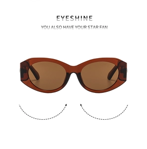 Detailed view of trendy cat-eye sunglasses with thick amber frames and sleek gold accents