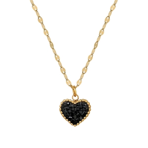 Macro detail of gold plated titanium necklace featuring a black crystal pavé heart pendant