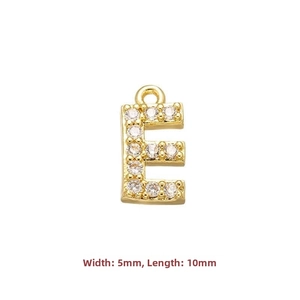 Macro shot of gold letter E charm with cubic zirconia inlay for DIY jewelry making