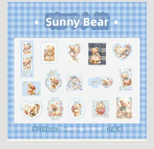 Detail of 30pcs vintage teddy bear stickers with blue heart and stamp shapes on plaid background