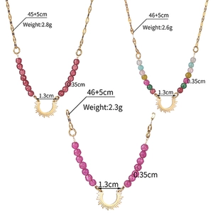 Detailed view of beaded necklaces with colorful beads and golden pendants in flat lay style