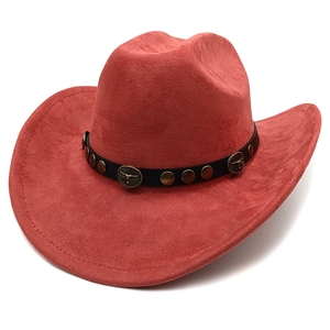 Detail of rust red faux suede cowboy hat featuring bull head studs and black leather band