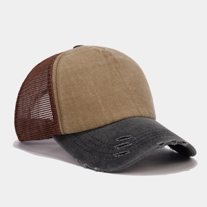 Close-up of distressed brim on a mesh truckercap with khaki, grey and brown colors