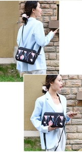 Floral oxford cloth crossbody bag featuring multiple zipper compartments and adjustable strap