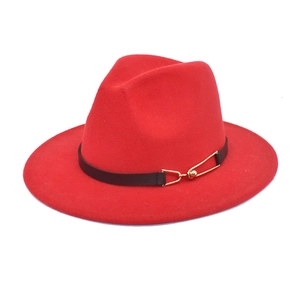 Detail of red wool fedora hat featuring black leather belt and gold buckle accent