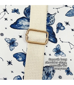 Detail of adjustable beige woven shoulder strap with gold buckle on butterfly print backpack