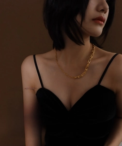 Detail of adjustable gold brick link bracelet worn on wrist with elegant urban style