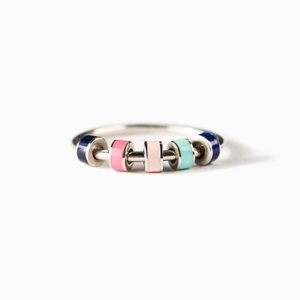 S925 silver anxiety ring with five colorful rotating enamel beads on a white background