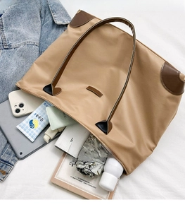 Spacious interior of khaki oxford tote showing high capacity for tablets and daily items