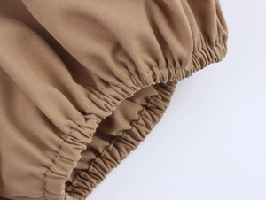 Close-up of elastic puff sleeve cuff in khaki cotton fabric showing detailed stitching