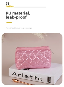 Close-up of pink quilted shiny PU leather makeup bag with classic diamond stitching pattern