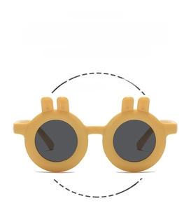 Close-up of yellow round frame kids sunglasses with rabbit ears and flexible design