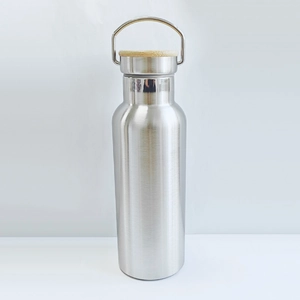 Detailed view of silver stainless steel water bottle with bamboo lid and metal handle