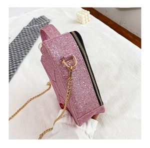 Close-up of pink sequin crossbody bag with star patterns and gold chain strap detail