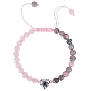 Detail of pink crystal and grey spotted stone beaded bracelet with heart projection pendant