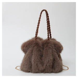 Detail of soft brown plush tote bag with woven handles and golden metal chain strap