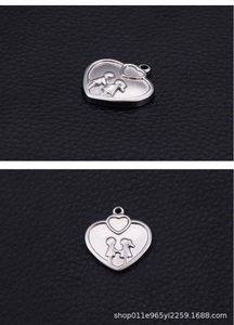 Macro detail of a heart-shaped silver pendant with an engraved couple holding hands