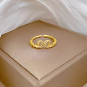 Adjustable gold infinity ring with white zircon and engraved Greek key pattern
