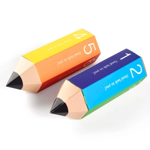 Detail view of pencil-shaped gift boxes in bright colors with Good Luck printing