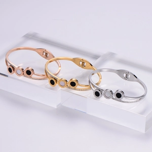 Polished stainless steel bracelets in gold, silver, and rose gold with Roman numerals