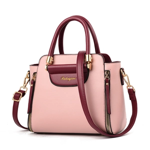 Chic pink and burgundy patchwork leather handbag with top handle and gold hardware