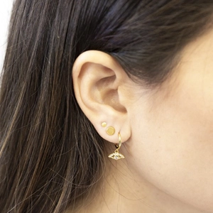 Close-up of gold S925 silver needle earrings with zircon eye pendant on female model
