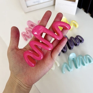 Large wavy cream-colored hair claw clip in magenta with vibrant candy color set