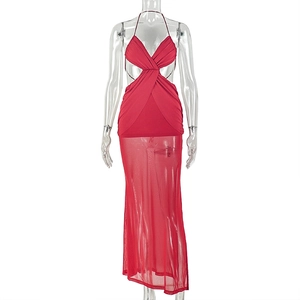 Detail of red halter mesh dress showing crossover waist cut-outs and sheer floor-length hem