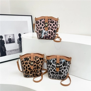 Chic leopard print bucket bags in pink, brown, and grey with glossy finish and gold twist lock