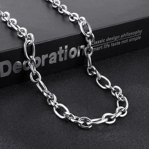 Close-up of polished silver stainless steel link chain over a black textured box